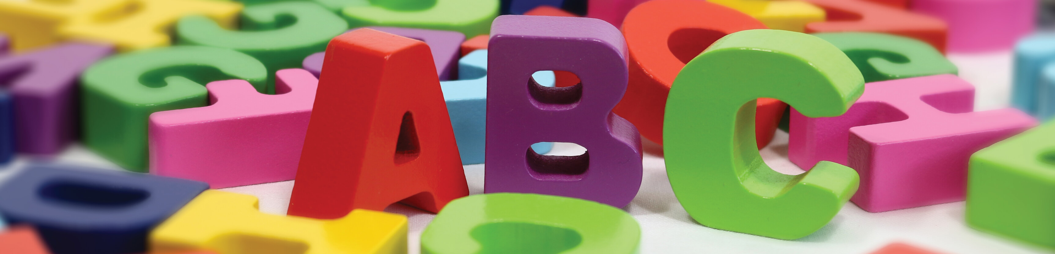 A group of different-colored, letter blocks with the letters A, B, and C standing in the middle